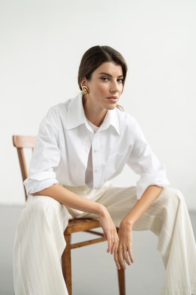 Patient seated in soft daylight, neutral linen styling