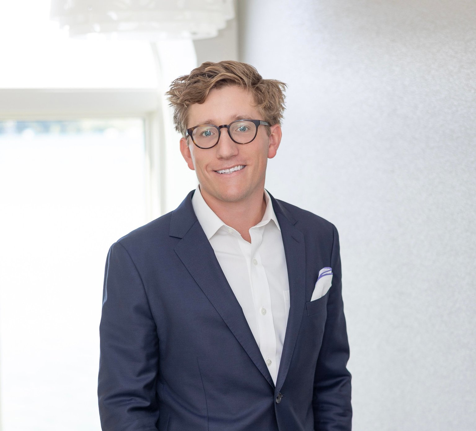 Dr. Lucas Boehm, board-certified plastic surgeon, formal editorial portrait in soft daylight