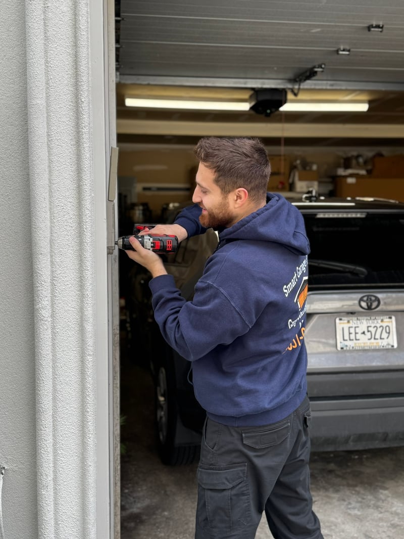 Smart Garage Doors technician drilling into garage door track hardware