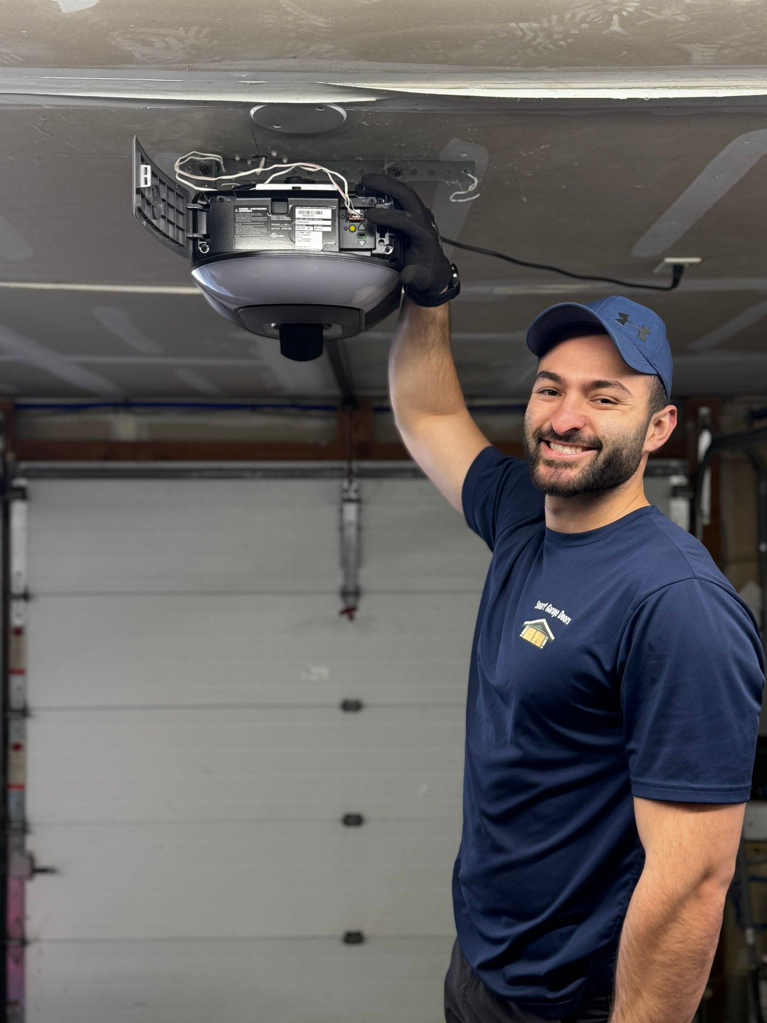 Smart Garage Doors technician performing garage door opener repair in Queens NY