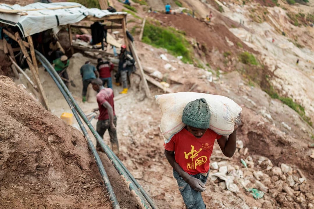 A laborer shoulders a sack of ore at the Rubaya coltan mine on March 24, 2025. REUTERS/Zohra Bensemra