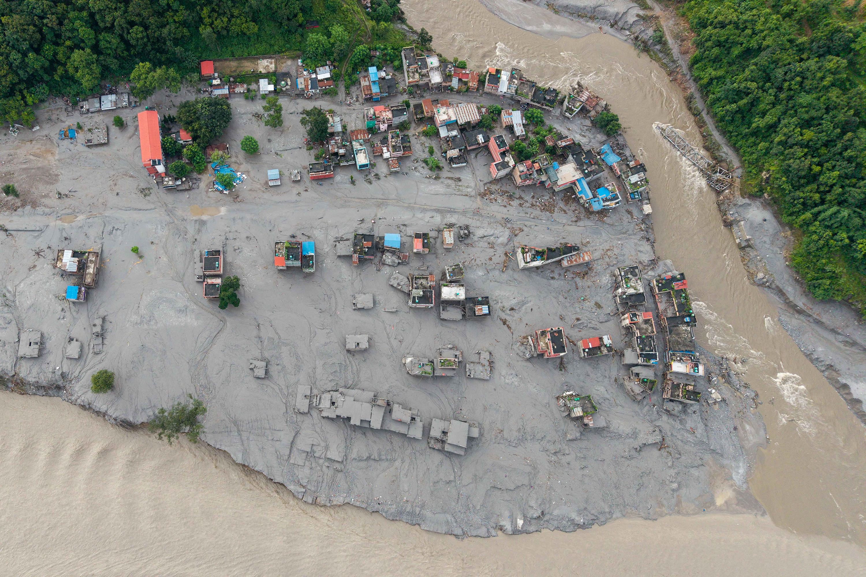 Houses lying deluged in sludge after flash floods at Devighat in Nepal, Aug. 27, 2026 - AFP