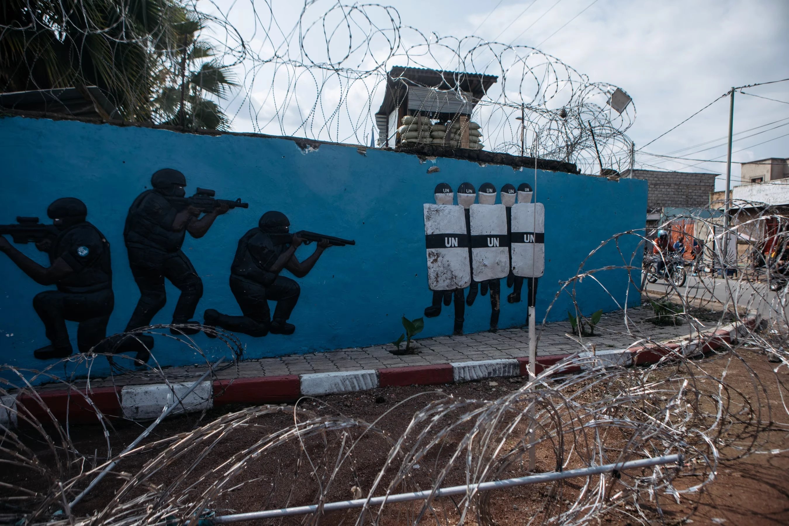 Abandoned ammunition at Goma International Airport; barbed wire around the entrance to a U.N. mission center. KC CHENG FOR WSJ