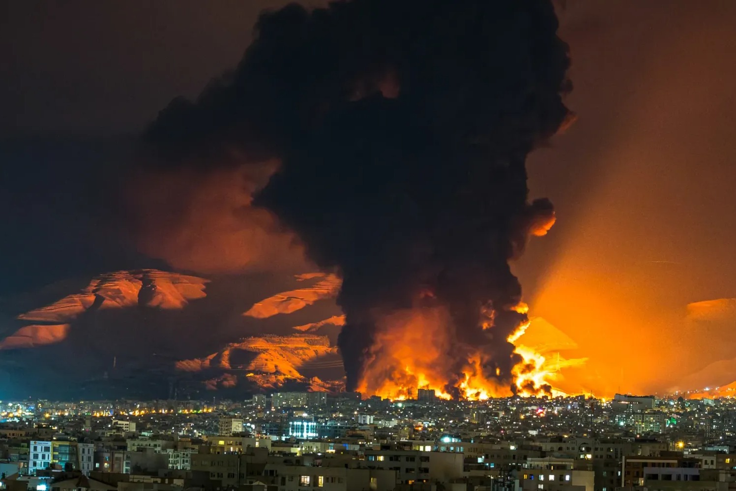 Smoke and flames rise at the site of airstrikes on an oil depot in Tehran - AFP