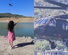 Skorsky pilotu kendini selamlayan küçük kıza el sallayarak karşılık verdi