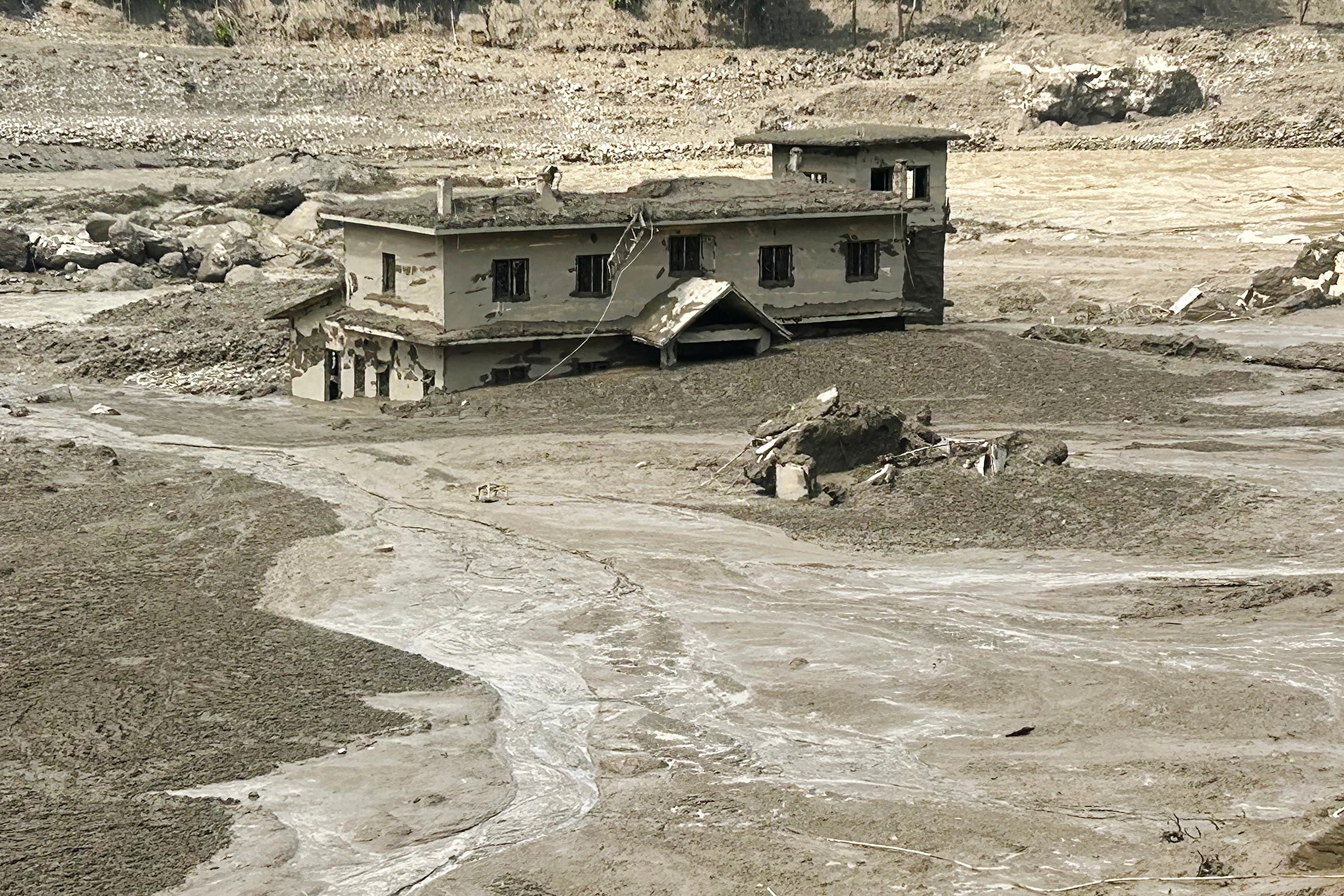 A house partially submerged by mud following flash floods and a landslide disaster in Trishuli Bazar, Aug. 26, 2026 - AFP