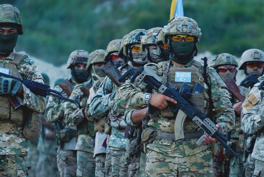 TIP fighters in Syria's Idlib during military parade