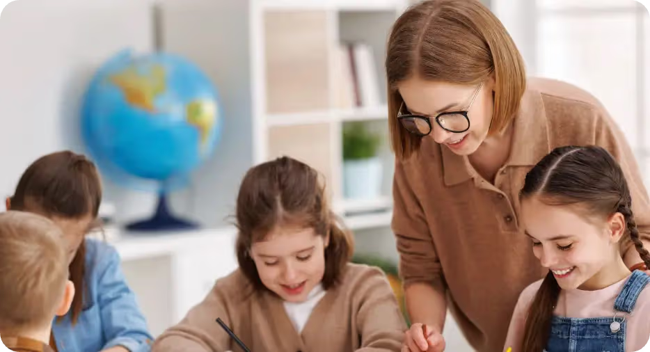 Teacher helping children study mathematics