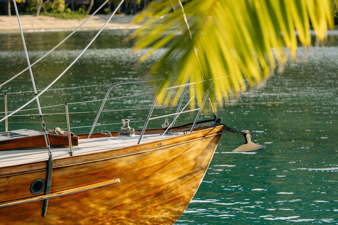 Overwater bungalows with thatched roofs extending into the clear blue ocean