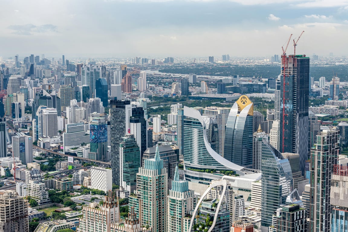 Aerial view of a bustling cityscape showcasing modern skyscrapers and vibrant urban development.