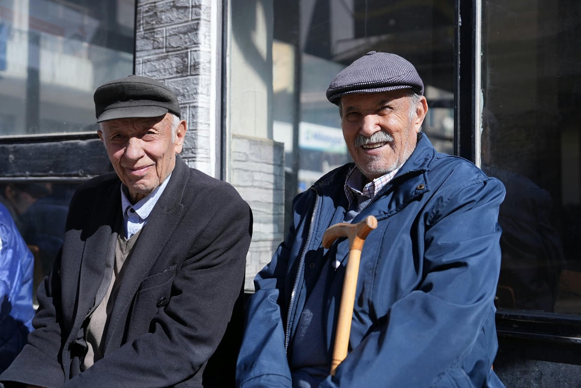 Elderly men enjoy a sunny day outside in Malatya, Türkiye.
