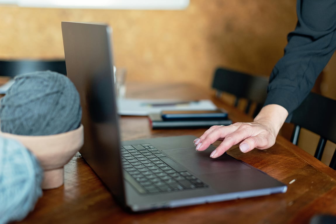 A person works remotely on a laptop in a cozy indoor setting, embodying the digital nomad lifestyle.