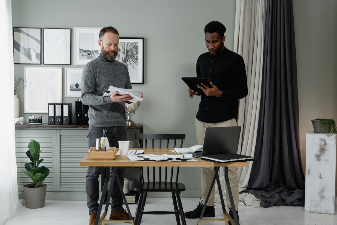 Two professionals discussing documents in a modern and stylish office environment.