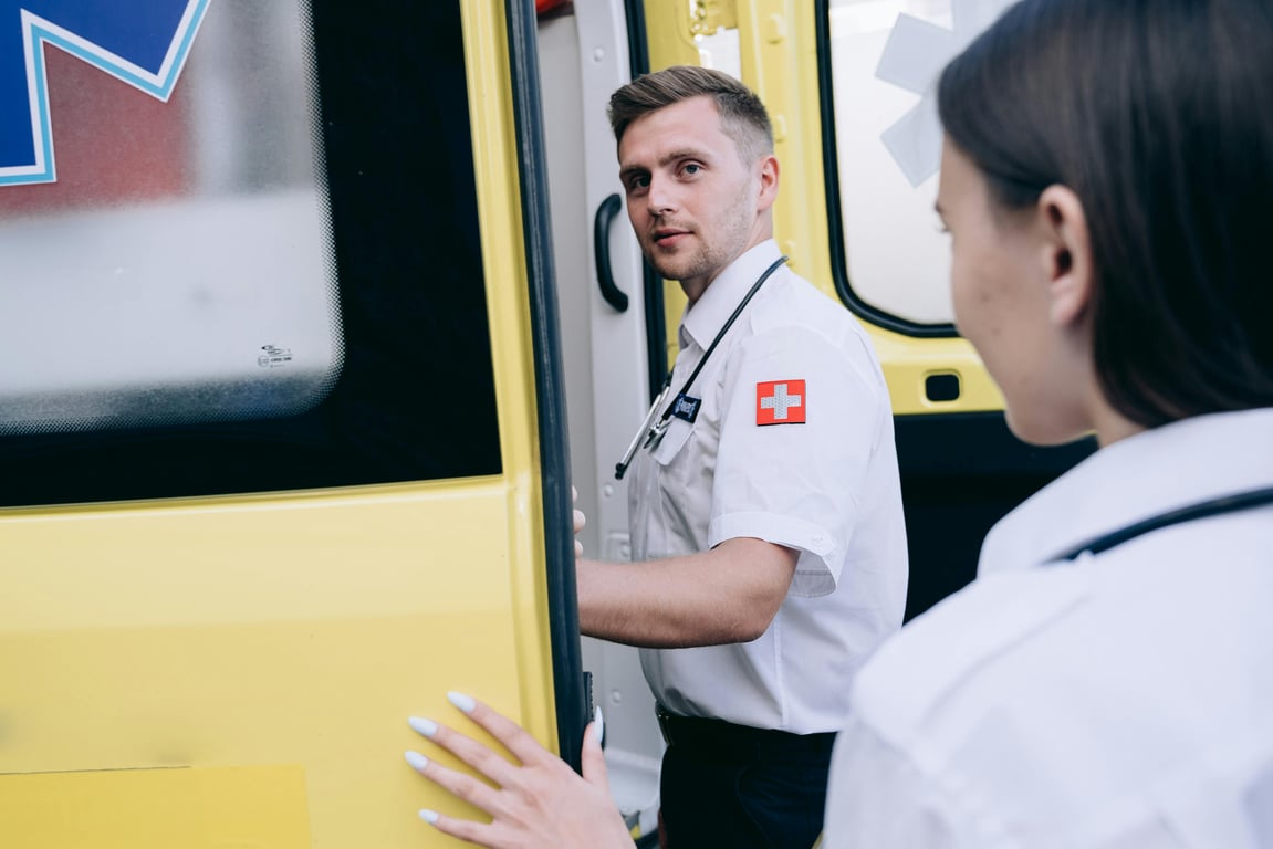 Paramedics entering ambulance ready for emergency response, showcasing teamwork and healthcare professionalism.