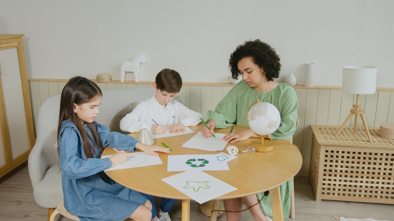 Children engage in environmental studies with drawings in a classroom setting.