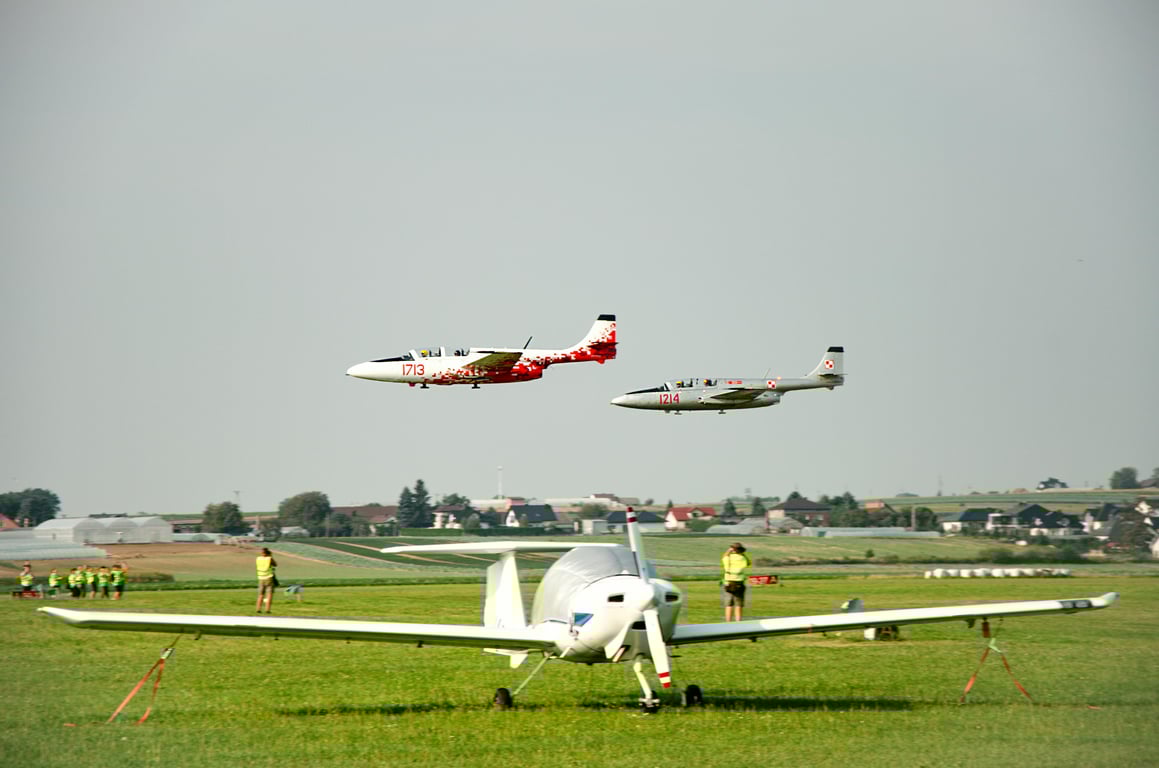 Multiple aircraft on a runway under clear skies, showcasing aviation and travel.