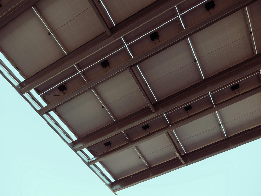 Close-up view of solar panels with a blue sky, showcasing renewable energy architecture.