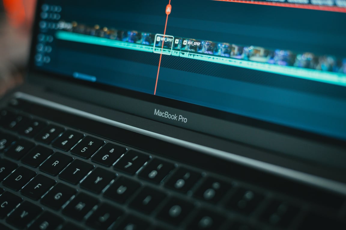MacBook Pro with video editing software highlighting a timeline, showcasing technology in action.