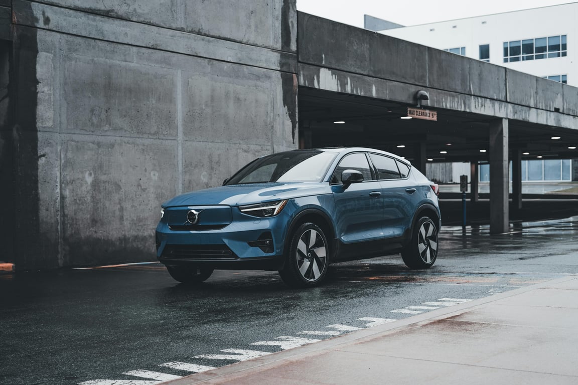 Blue Volvo SUV parked in a modern urban environment showcasing sleek design and urban lifestyle.