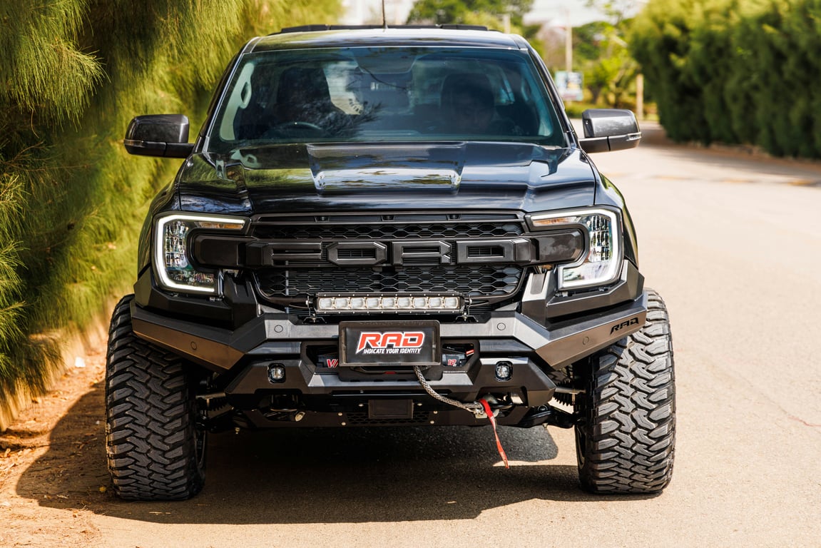 Front view of a customized Ford truck featuring a RAD off-road kit, parked outdoors.