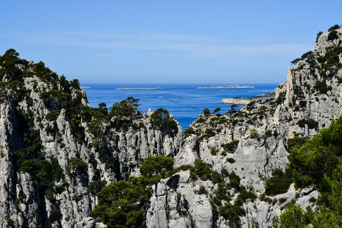 Discover the stunning limestone cliffs and azure waters of Calanques National Park in Provence, France.