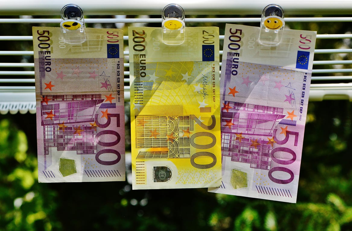 Euro currency notes clipped to a line, symbolizing finance concepts like money laundering or savings.