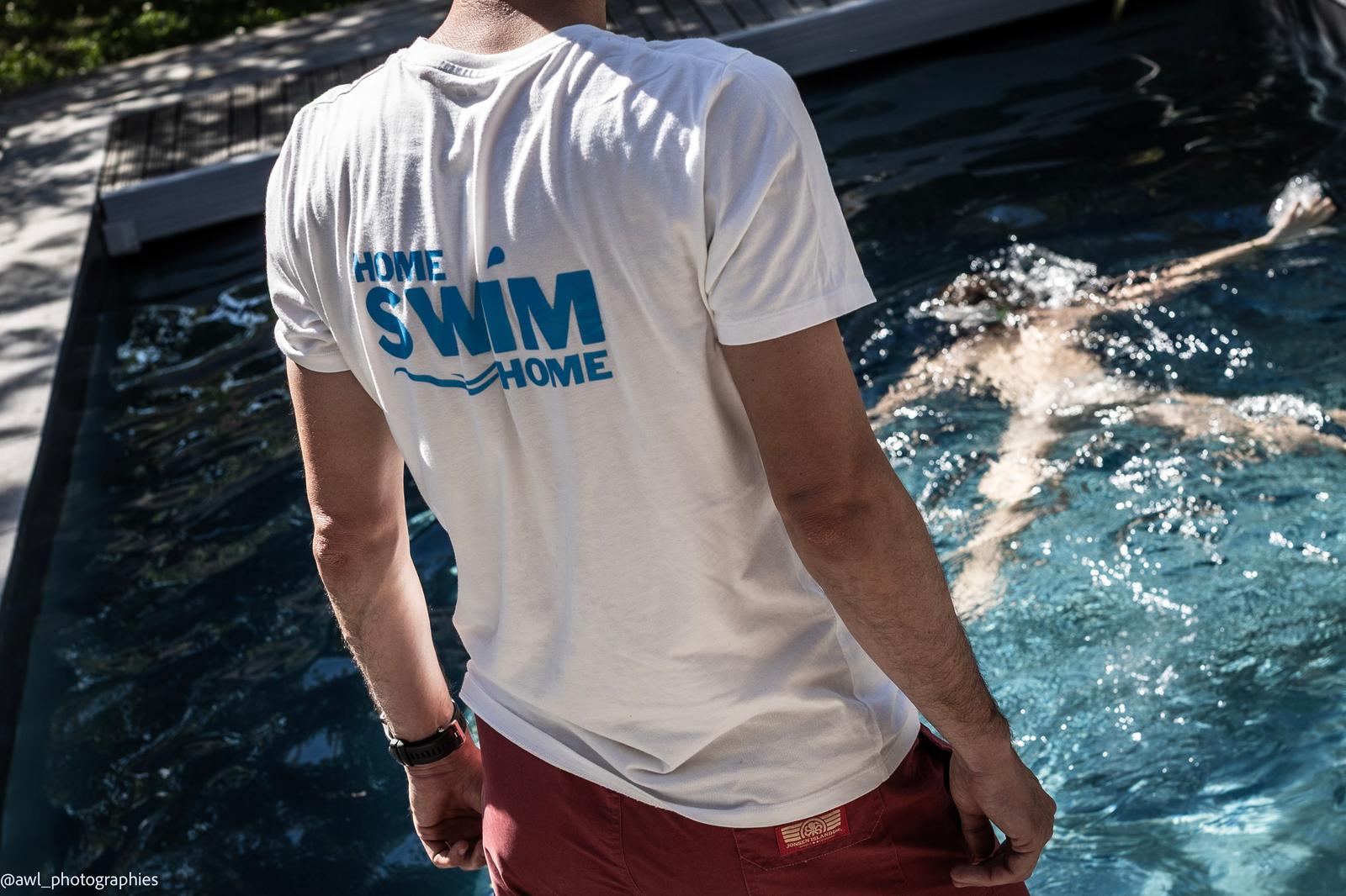 Dans l'eau, un maître-nageur Home Swim Home surveille un enfant qui nage
