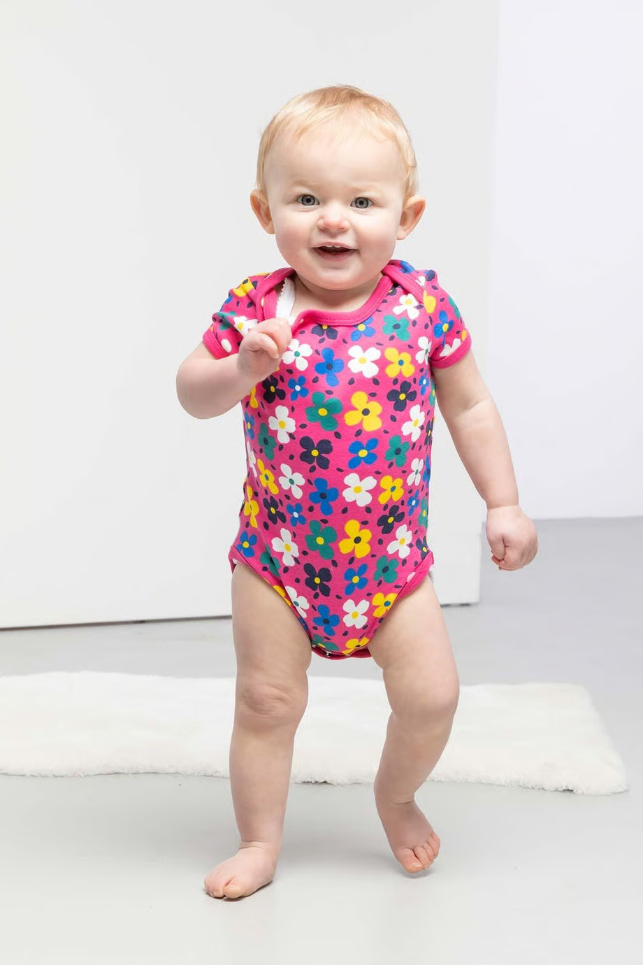 Baby in pink bodysuit