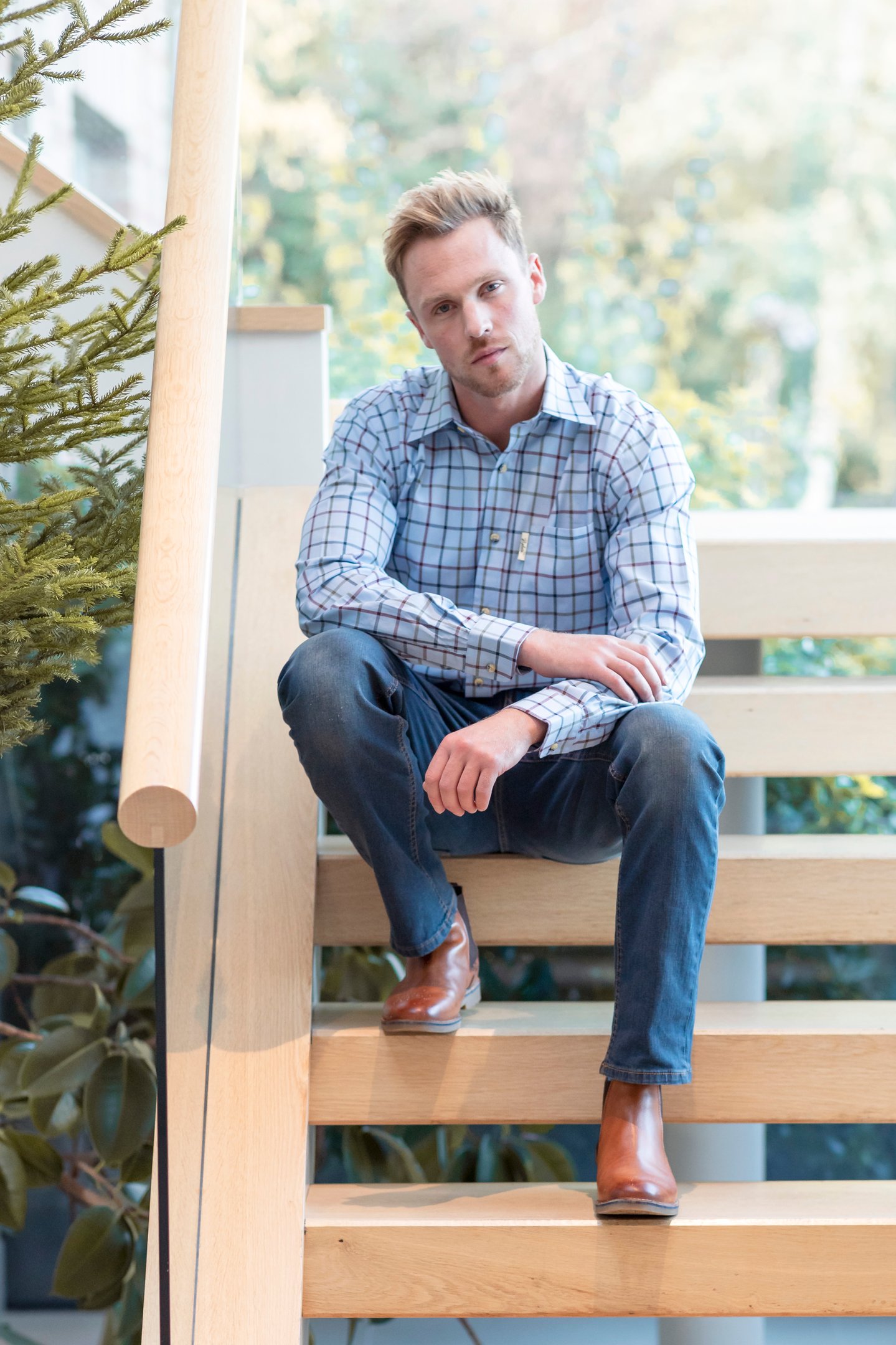 man wearing leather chelsea boots with chinos and a shirt