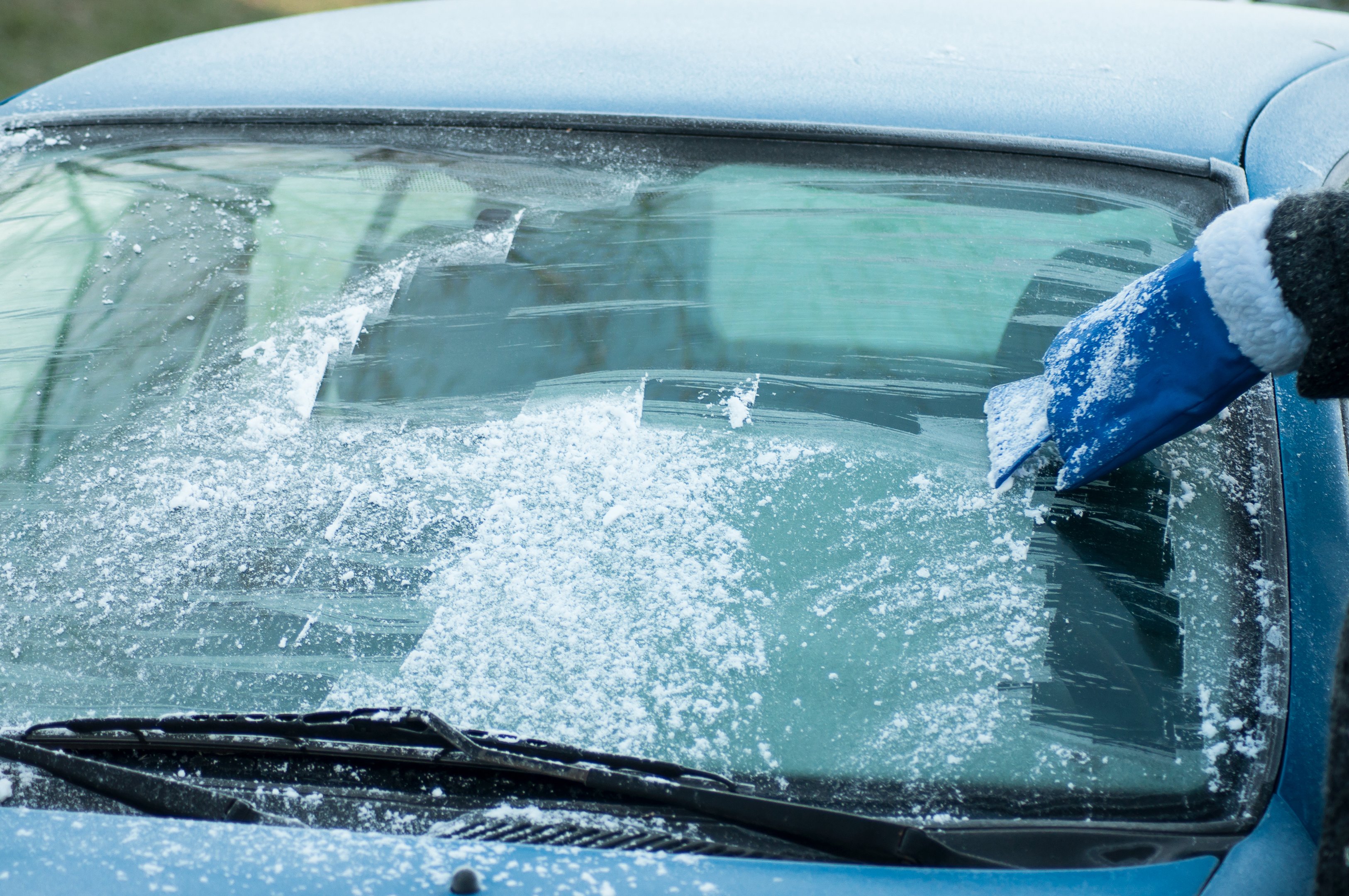 Scraping ice from car windscreen