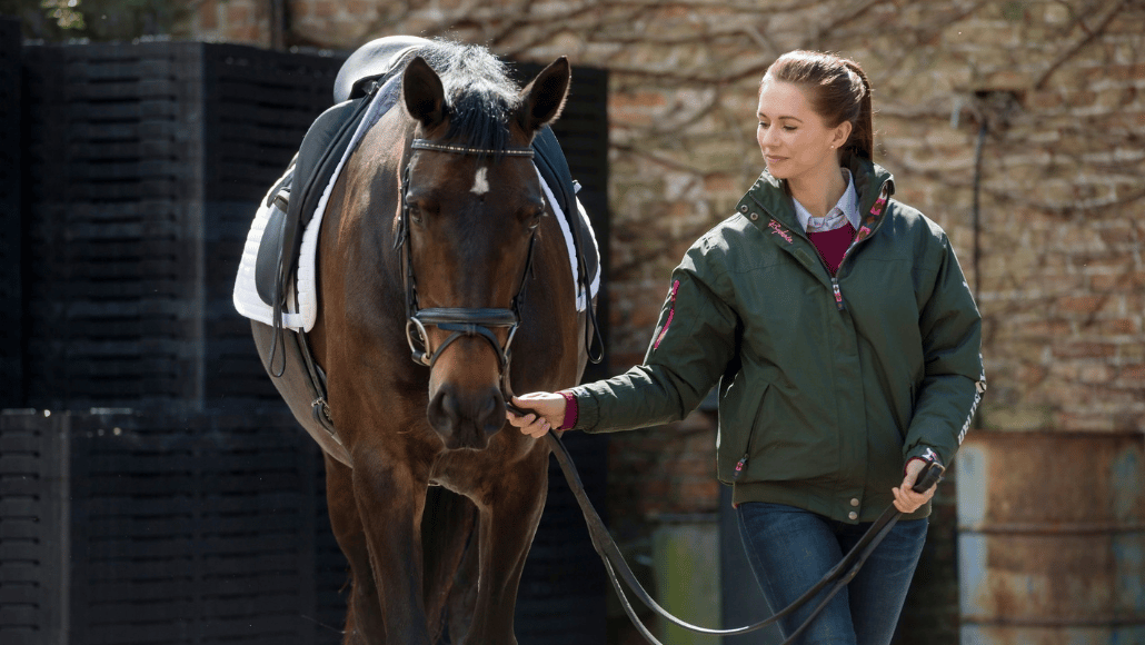 Lady preparing for a bridleway hack with her horse.