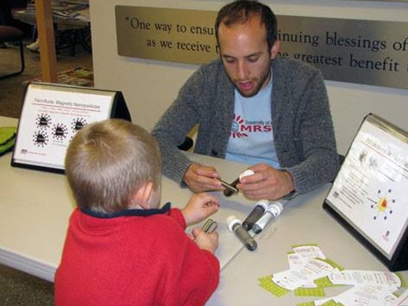 Assistant Director of Education, Ben Taylor, leads materials science activities with a student at the St. Vincent de Paul Society food pantry in Madison, Wisconsin.