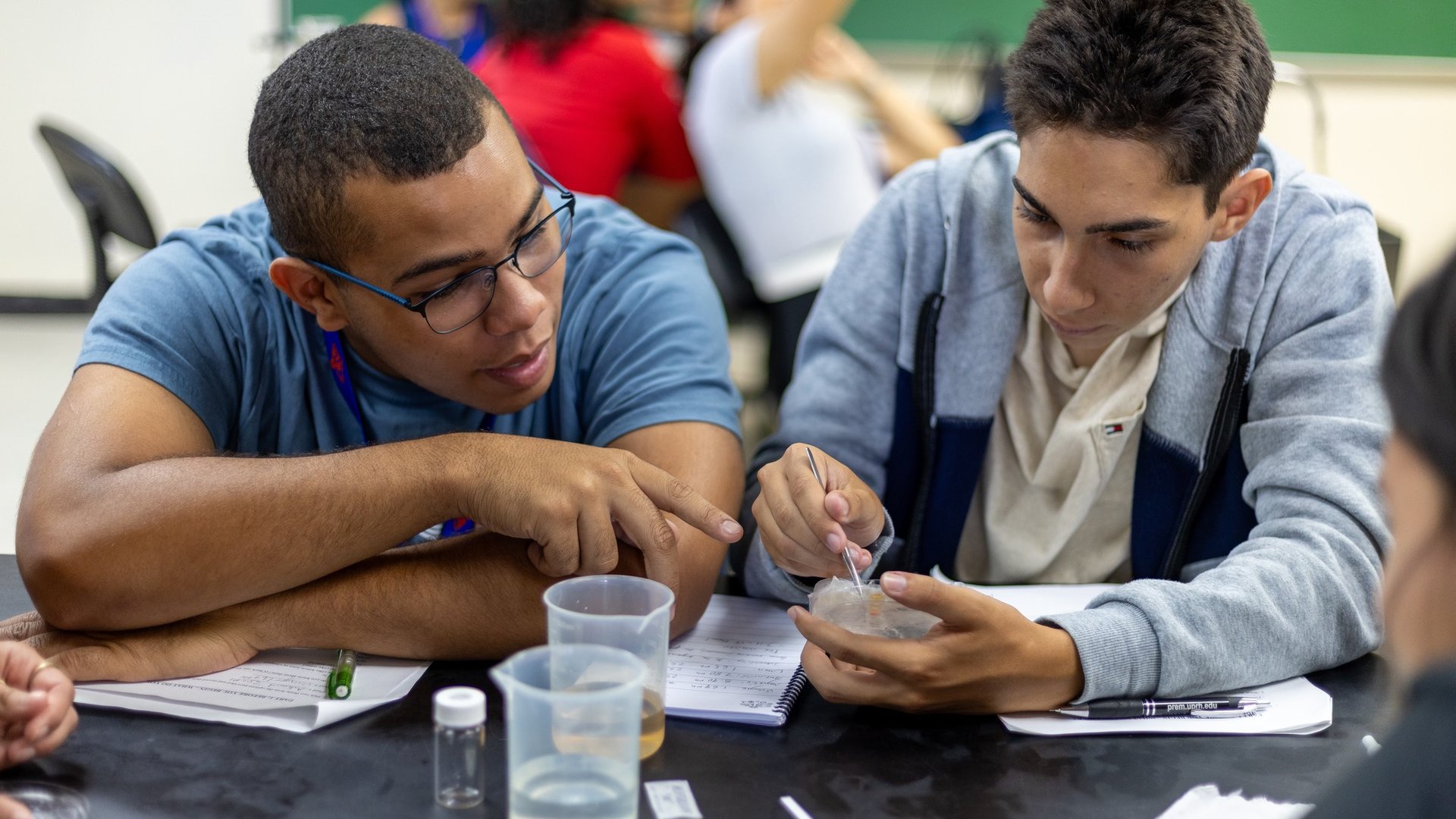 A student works with faculty on an experiment as part of 