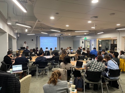 Volker Blum giving a lecture to workshop participants in Duke University’s Ahmadieh Family Grand Hall in Gross Hall for Interdisciplinary Innovation, the workshop venue.
