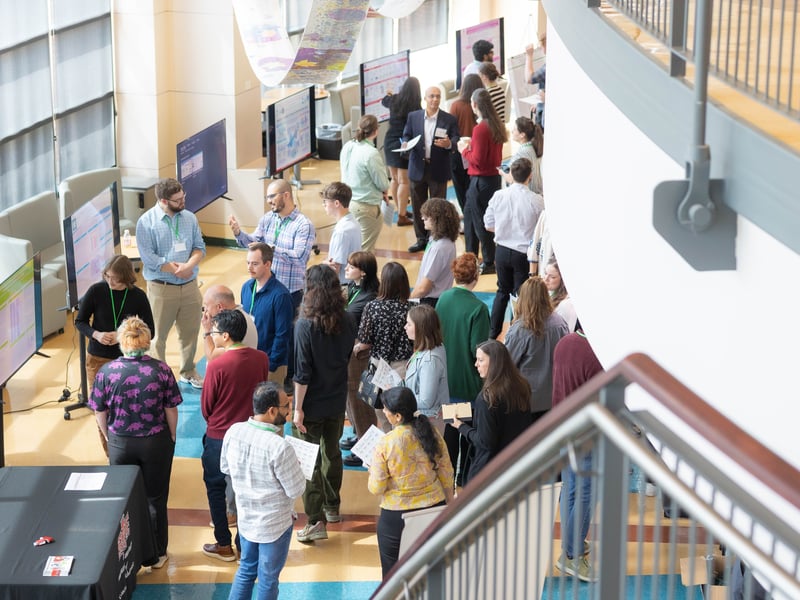 Attendees view research posters and connect with presenters during the 2026 Biotechnology Symposium at NorthWest Arkansas Community College.