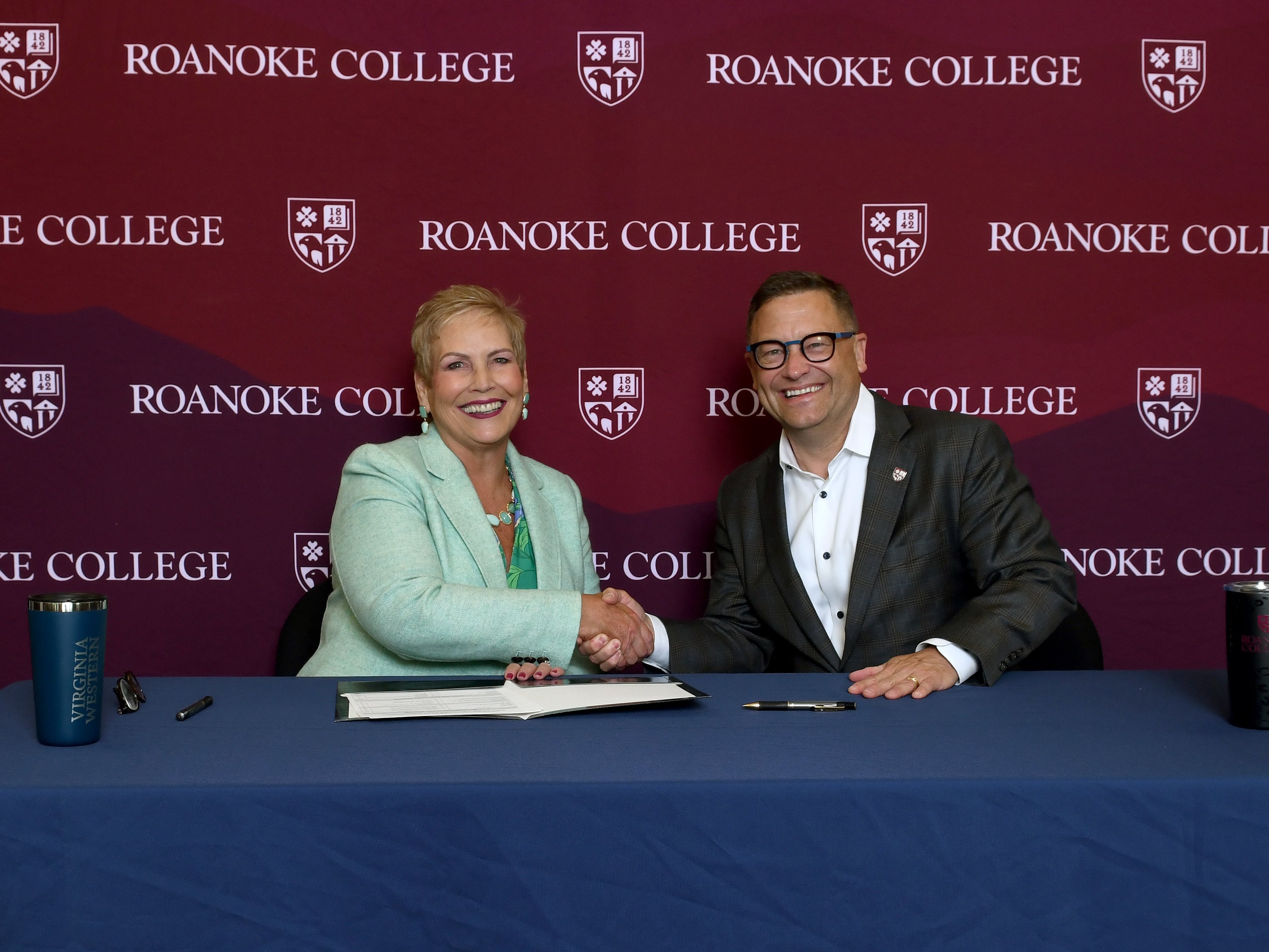 Laura Treanor, President of Virginia Western, and Frank Shushok Jr., President of Roanoke College, sign a memorandum of understanding to launch a new bachelor’s in biotechnology. Image courtesy of Roanoke College.