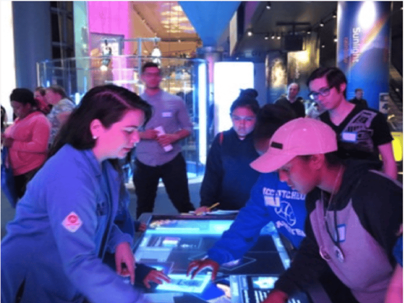 Volunteers and attendees interact during HerStory at the Chicago Museum of Science and Industry.