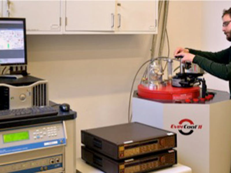 Mehmet Noyan loads a sample into the helium re-liquefier.