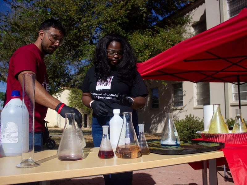 Students demonstrating a chemical reaction during NMSU's Physics Fun Day, outside Gardiner Hall, March 27. Image credit: Elijah Rey Reyes 