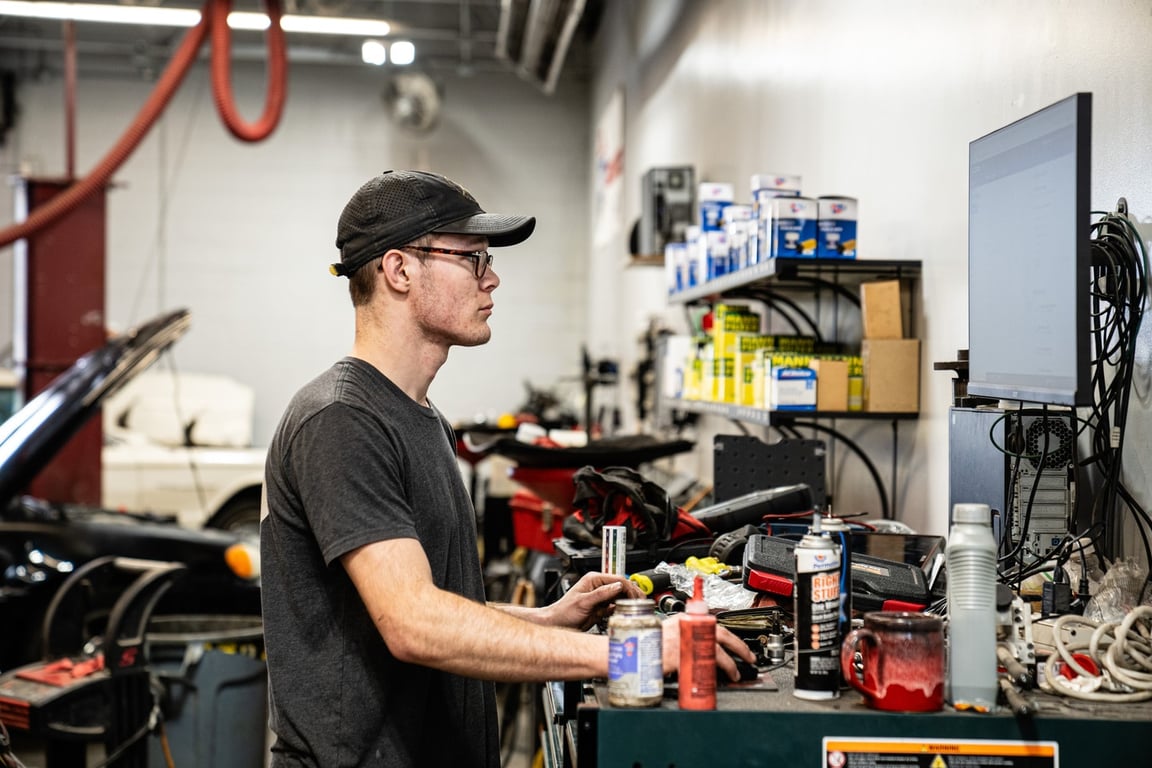 Auto technician looking up information on computuer