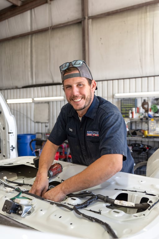 Smiling collision repair technician in the shop