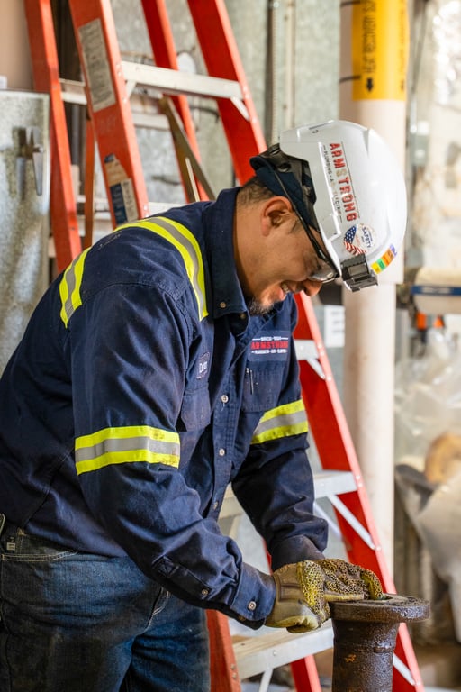 Technician holding a length of metal pipe