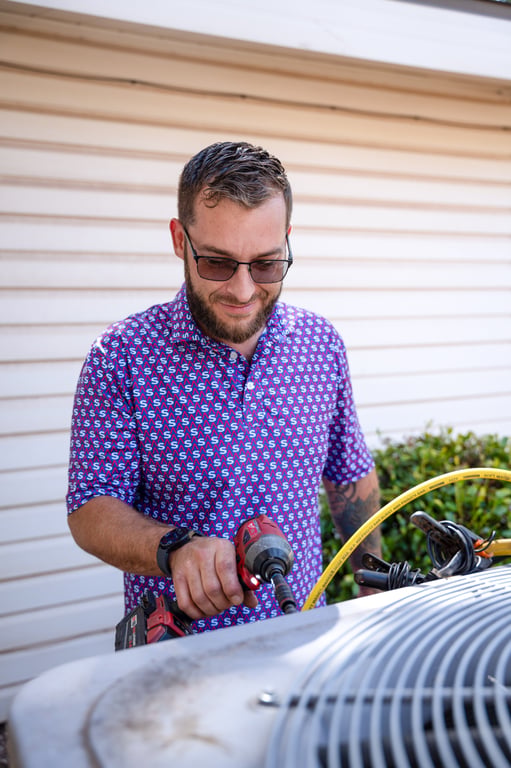 Technician servicing an outdoor condenser unit
