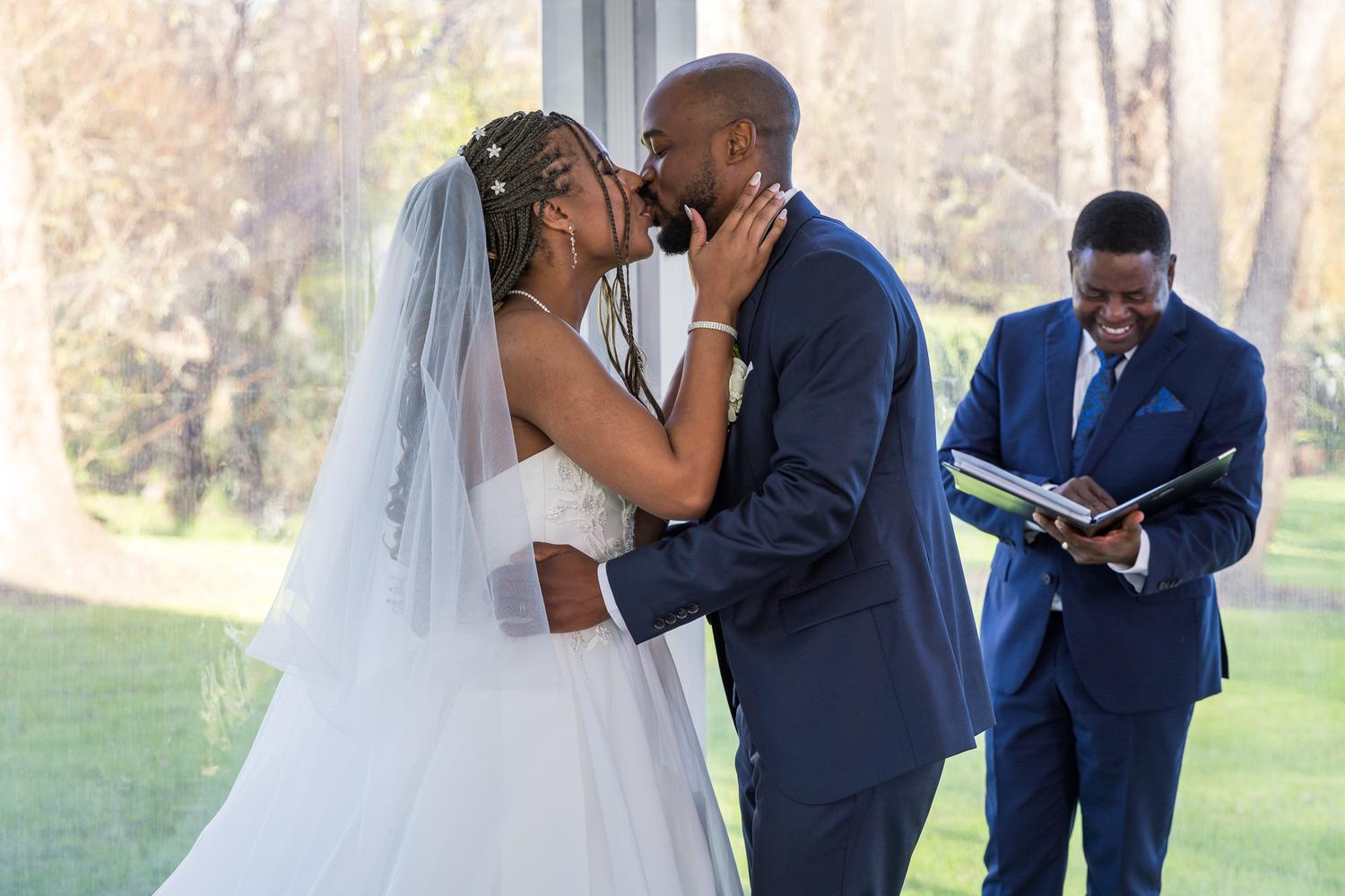 Foster kisses Chiedza as the celebrant smiles