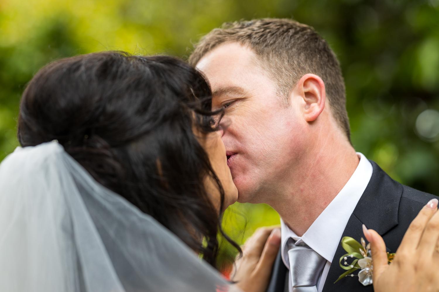 Feby and Steven share a kiss among the greenery