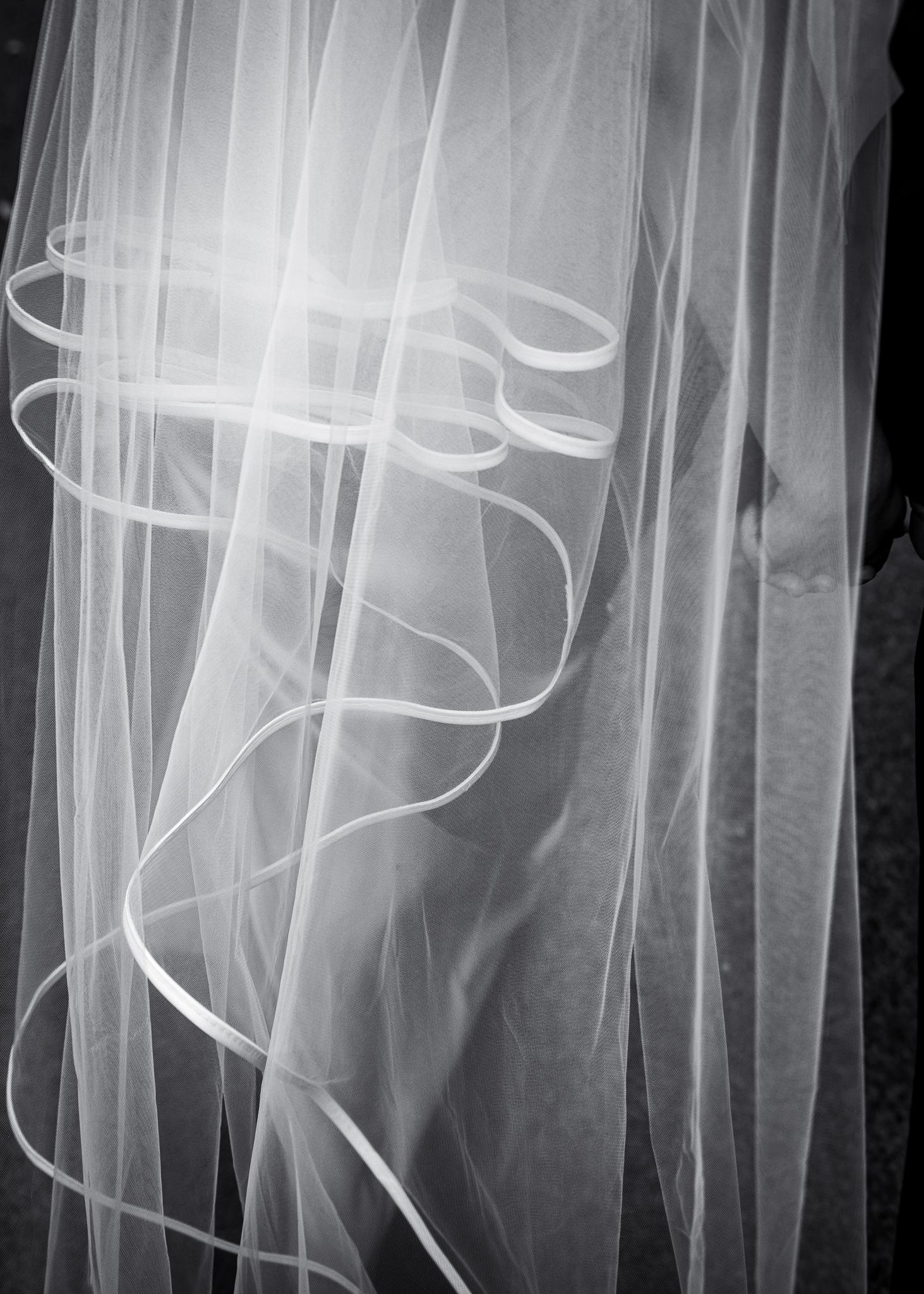 Black and white close-up of the ribbon edge of Feby's veil