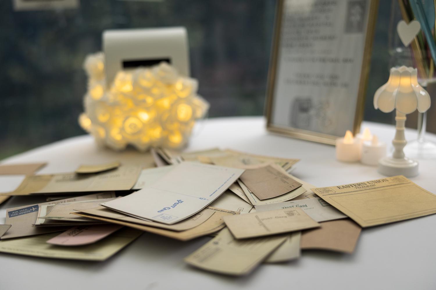 Handwritten guest cards beside a jar of fairy lights