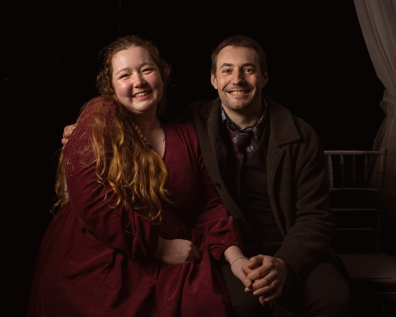Two guests smile for a portrait