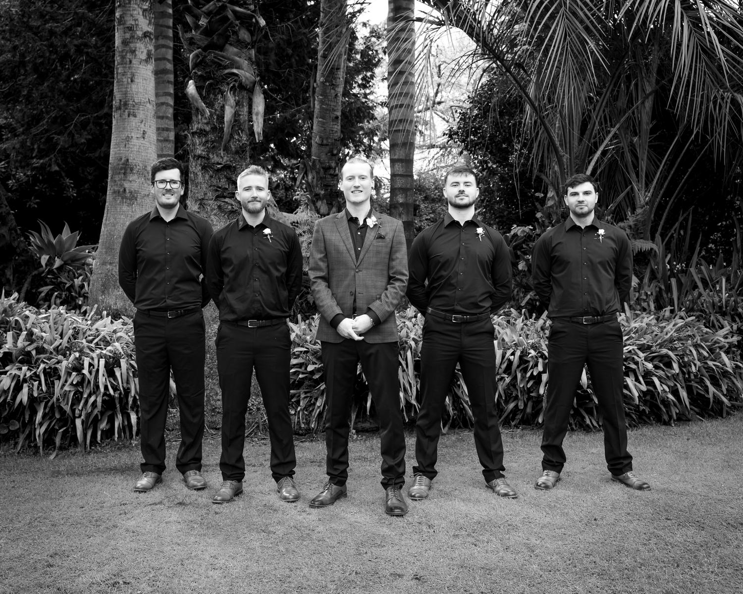 Black and white photo of the groomsmen in a line