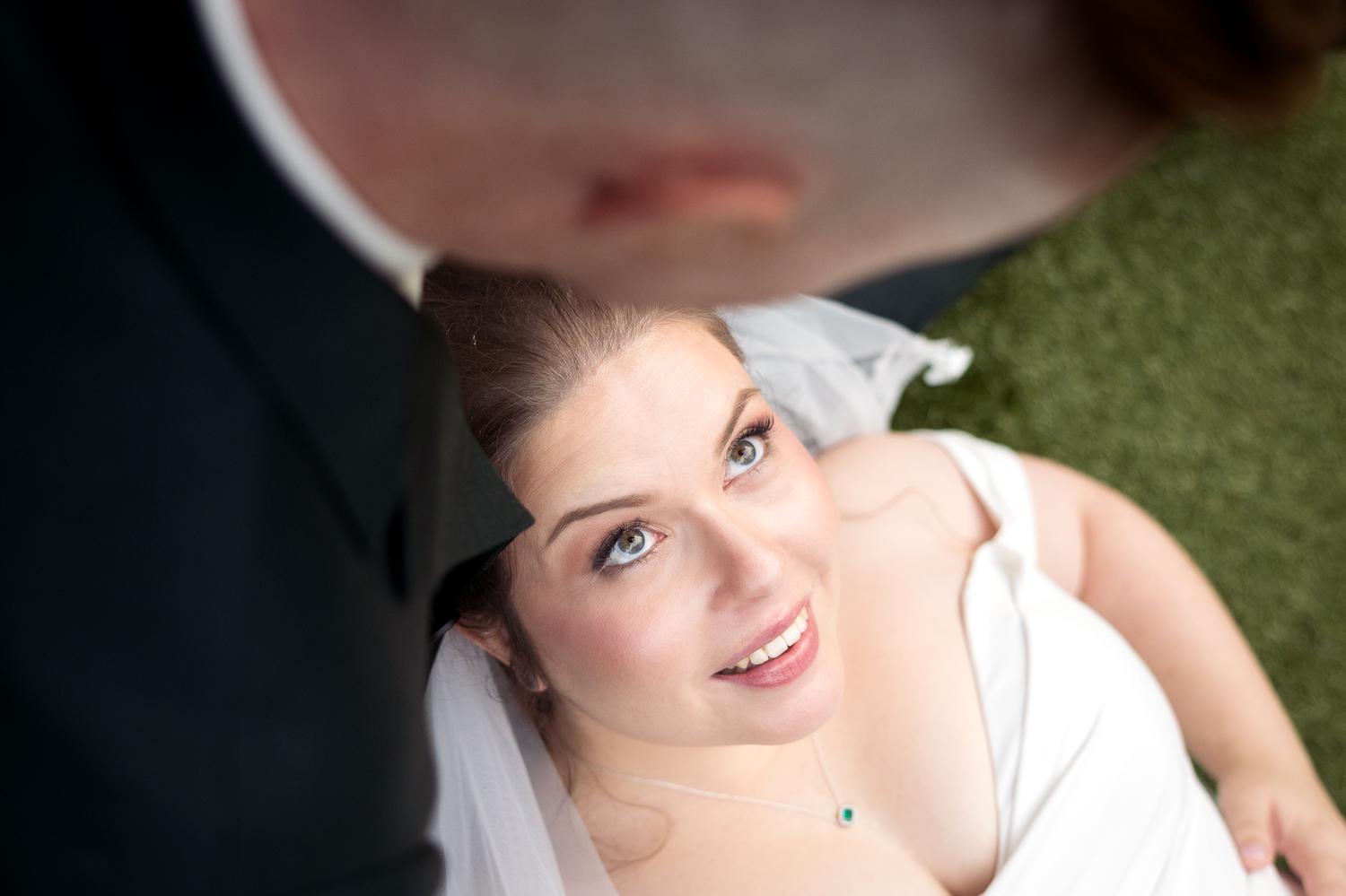 A bride gazes up at her groom at Tui Hills
